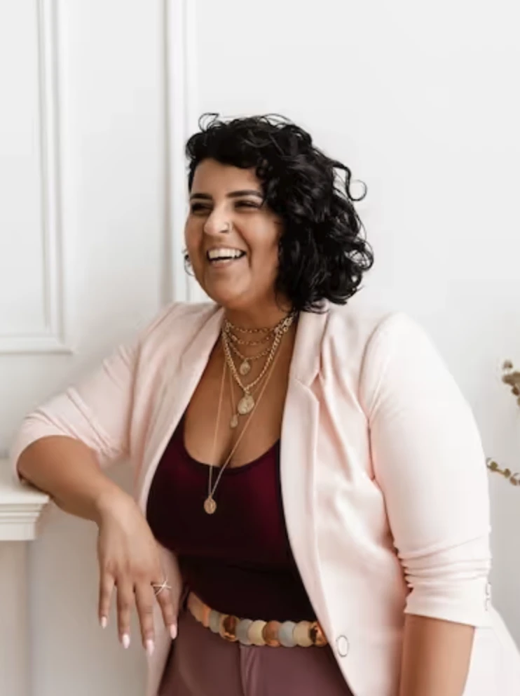 Hiba, a trauma therapist, smiling in her studio